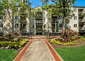 Thumbnail 6 of 41 - A pathway leads to a building with a green lawn on either side.