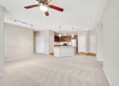 Thumbnail 29 of 48 - an empty living room and kitchen with a ceiling fan