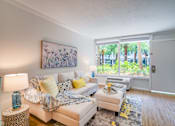Thumbnail 2 of 24 - a living room with a couch and a large window