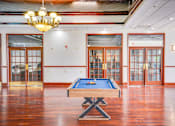 Thumbnail 17 of 24 - a games room with a pool table and a chandelier