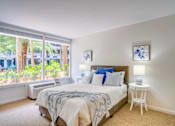 Thumbnail 11 of 24 - bedroom with expansive windows and carpeted floor