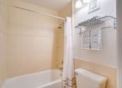 Thumbnail 13 of 24 - a bathroom with a shower and a toilet and a tub