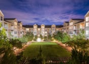 Thumbnail 39 of 39 - an aerial view of an apartment complex at night with a green courtyard