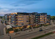 Thumbnail 54 of 54 - A large, modern building with a lot of windows and a sign that says "East Street.".