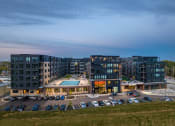 Thumbnail 2 of 53 - an aerial view of a building with a pool and parking lot