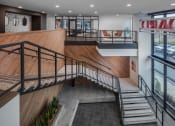 Thumbnail 9 of 53 - the lobby of a building with stairs and a wooden ramp
