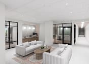 Thumbnail 15 of 21 - A modern living room with a white sofa and a wooden coffee table.