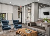 Thumbnail 12 of 61 - a lobby with couches chairs and a coffee table