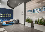 Thumbnail 3 of 61 - the current office lobby with chairs and a table and the sign for the current