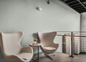 Thumbnail 19 of 61 - two chairs in a room with a railing and a table