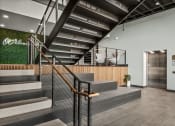 Thumbnail 20 of 61 - the lobby of a building with a staircase and a green wall