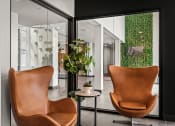 Thumbnail 23 of 61 - a living room with two brown chairs and a green wall