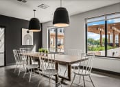 Thumbnail 26 of 61 - a dining room with a wooden table and white chairs