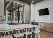 Thumbnail 8 of 61 - a kitchen with a white counter top and white chairs