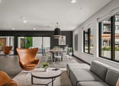 Thumbnail 29 of 61 - a living room with a couch and a table and chairs