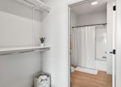 Thumbnail 29 of 53 - A white bathroom with a white shower curtain and a white towel.