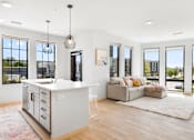 Thumbnail 48 of 53 - A modern kitchen with a large island and a view of the city.