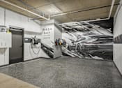 Thumbnail 13 of 26 - A car wash bay with a large mural of a car on the wall.