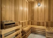 Thumbnail 20 of 26 - A wooden sauna with benches and a heater.