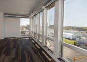 Thumbnail 34 of 84 - A living room with hardwood floors and large windows at The Landing at 1001 NP, Fargo, North Dakota 58102