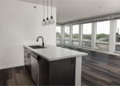 Thumbnail 33 of 84 - A kitchen with a large window and a large island with a sink and a faucet planat The Landing at 1001 NP, Fargo, North Dakota 58102