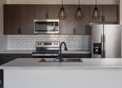 Thumbnail 42 of 84 - a kitchen with a stove a sink and a refrigerator at 1001 NP, Fargo, North Dakota, 58102