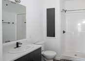 Thumbnail 13 of 17 - Modern bathroom with walk in shower at The Avery - Residential Apartments, Fargo, 58102