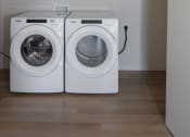 Thumbnail 23 of 27 - a washer and dryer in a laundry room at Riverhouse Apartments, Fargo, North Dakota 58102