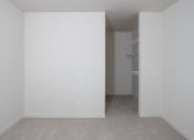 Thumbnail 15 of 27 - an empty room with white walls and a closet at Riverhouse Apartments, North Dakota