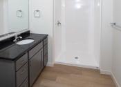 Thumbnail 11 of 27 - a small bathroom with a sink and a shower at Riverhouse Apartments, Fargo, ND 58102