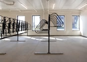 Thumbnail 16 of 17 - Bike storage rack in modern indoor space at The Avery - Residential Apartments, North Dakota, 58102