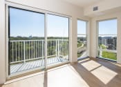 Thumbnail 5 of 27 - a living room with large windows and a view of the city at Riverhouse Apartments, Fargo, ND