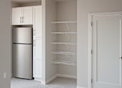 Thumbnail 6 of 17 - Walk in pantry with stainless steel refrigerator at The Avery - Residential Apartments, Fargo, 58102