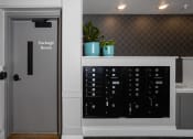 Thumbnail 27 of 50 - a room with a door to a locker and a shelf with potted plants  at Dillard Apartments, Fargo, ND 58102