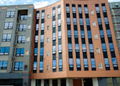 Thumbnail 1 of 17 - Modern apartment building exterior with vertical design at The Avery - Residential Apartments, North Dakota