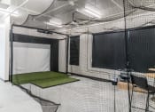 Thumbnail 24 of 27 - a batting cage in a room with nets and a table at Riverhouse Apartments, Fargo, North Dakota