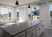 Thumbnail 17 of 60 - Kitchen island at Kesler Apartments in Downtown Fargo, Fargo, North Dakota 58102