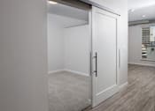 Thumbnail 12 of 60 - Spacious Rooms with White Sliding Farm Doors at Kesler Apartments in Downtown Fargo, Fargo ND 58102