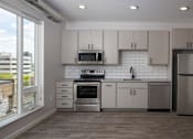 Thumbnail 3 of 60 - Contemporary Kitchen without Island at Kesler Apartments in Downtown Fargo, Fargo ND 58102