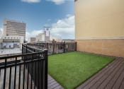 Thumbnail 29 of 50 - a turf lawn on the rooftop of a building at Dillard Apartments, Fargo, North Dakota 58102