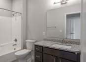 Thumbnail 31 of 37 - a bathroom with a toilet sink and shower  at RoCo Apartments, Fargo, ND 58102