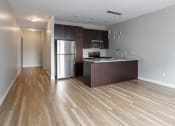 Thumbnail 13 of 37 - a kitchen with a large island and stainless steel appliances  at RoCo Apartments, Fargo, North Dakota 58102