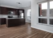 Thumbnail 29 of 37 - an open kitchen and living room with a large window  at RoCo Apartments, Fargo, ND 58102