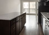 Thumbnail 16 of 37 - a kitchen with a counter top and a refrigerator at RoCo Apartments, Fargo, ND 58102