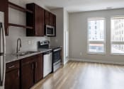 Thumbnail 19 of 37 - a kitchen with a stove top oven next to a window  at RoCo Apartments, Fargo, North Dakota 58102