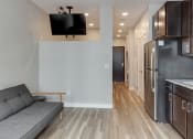 Thumbnail 17 of 37 - a living room with a couch and a tv  at RoCo Apartments, Fargo, North Dakota 58102