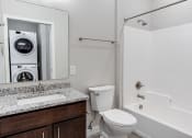 Thumbnail 35 of 37 - a bathroom with a washer and dryer in it  at RoCo Apartments, Fargo, North Dakota 58102
