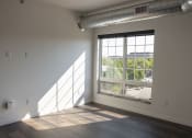 Thumbnail 48 of 84 - an empty room with a large window at The Landing at 1001 NP, Fargo, ND 58102