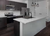 Thumbnail 50 of 84 - a kitchen with a sink stove and refrigerator at The Landing at 1001 NP, Fargo, 58102