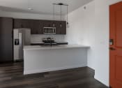 Thumbnail 52 of 84 - a kitchen with a white counter top and a stainless steel refrigerator at The Landing at 1001 NP, Fargo, ND, 58102